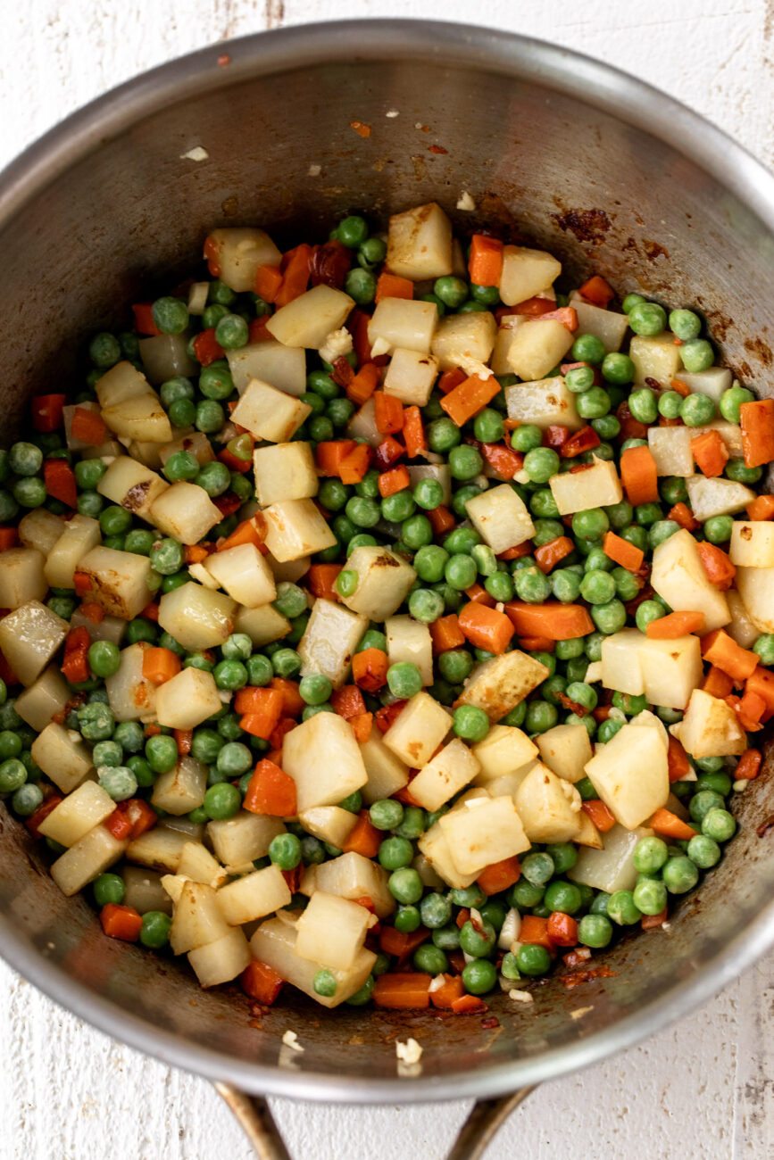 vegetables sautéed in large pot for chicken pot pie filling.
