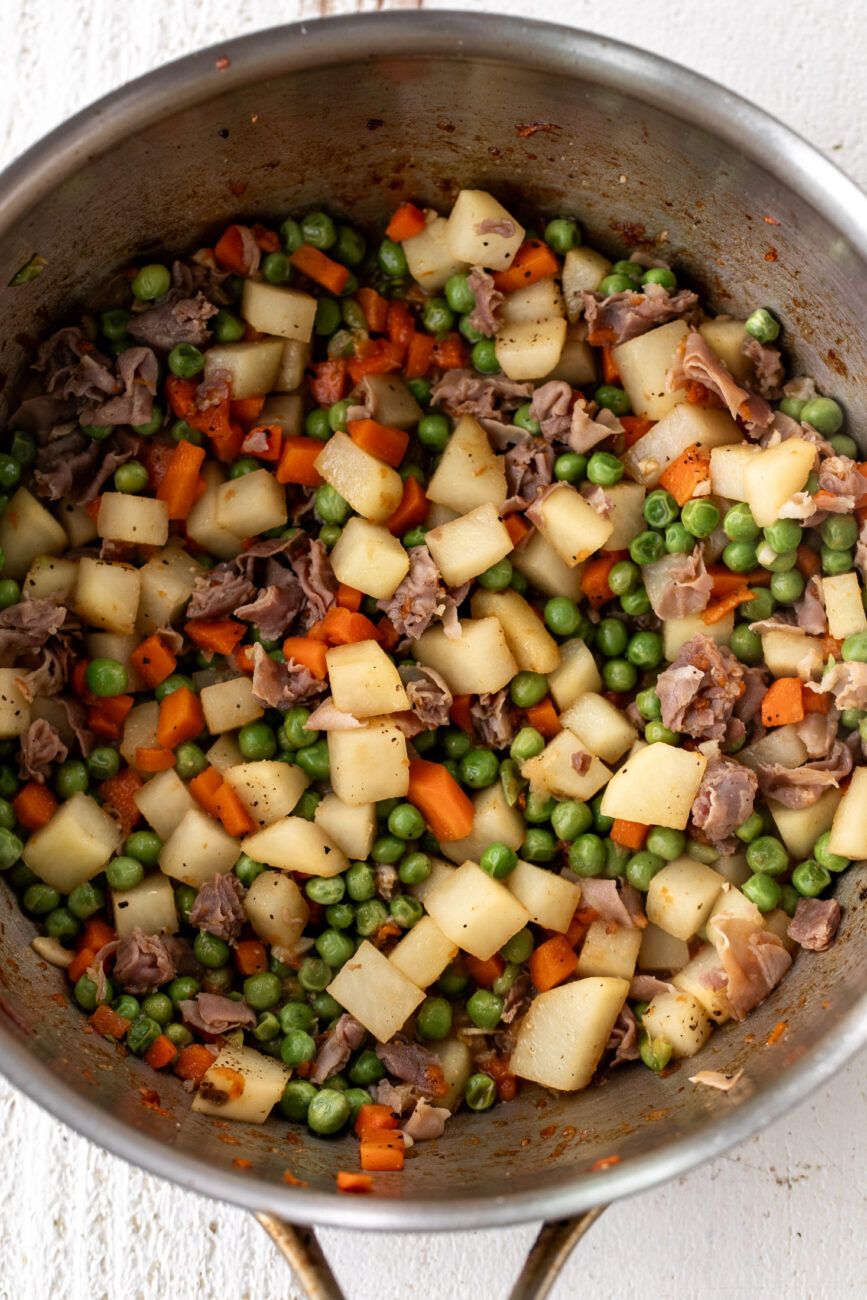 Chicken Pot pie with prosciutto filling in pot white wine deglazed.