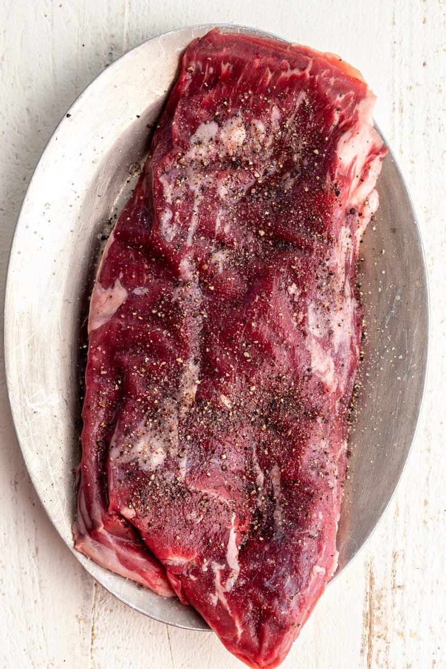 flank steak seasoned with salt and pepper.