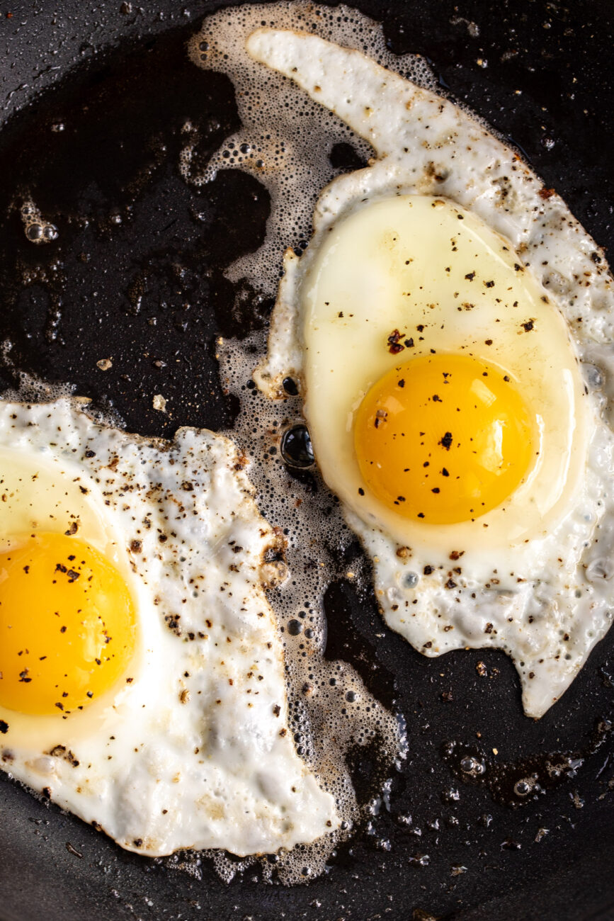 fried eggs in pan.