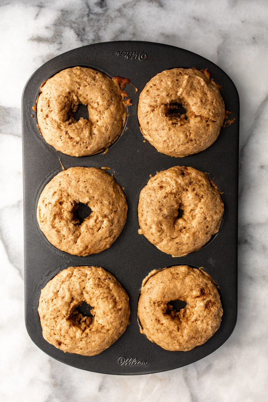 baked apple cider donuts in pan.