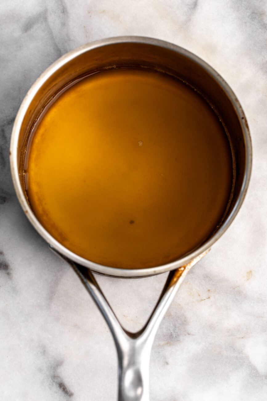 reduced apple cider in small pot.