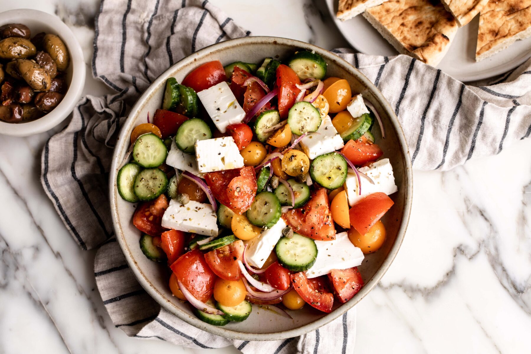 Greek salad with cucumber, tomatoes, onion and feta cheese.