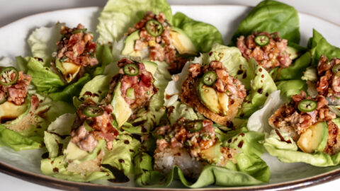 Crispy Rice Topped with Spicy Tuna avocado and jalapeño drizzled with eel sauce in butter lettuce cups.