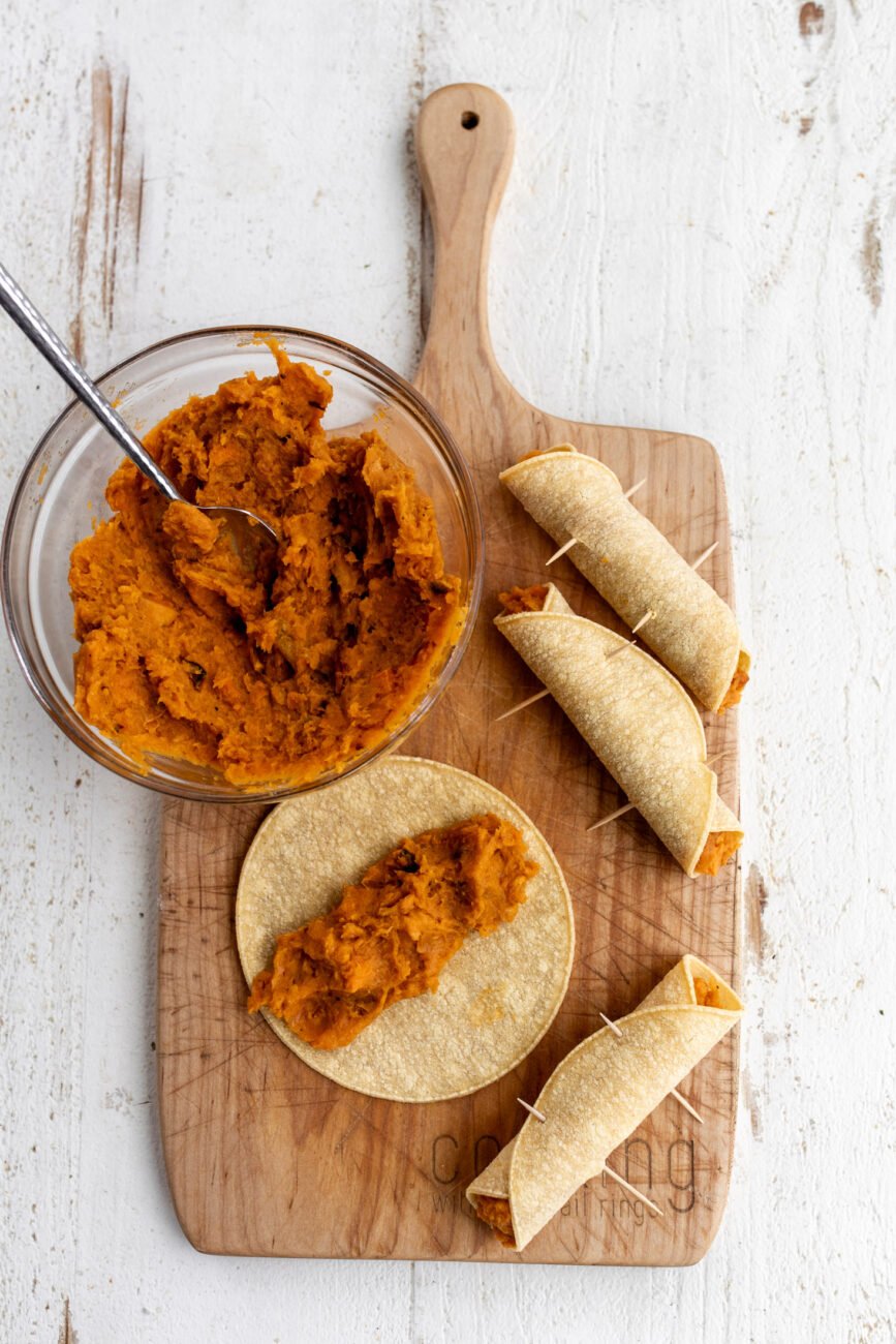 assembled sweet potato taquitos rolled in corn tortillas.