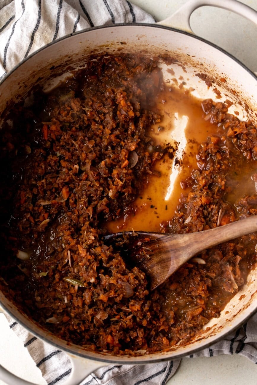 deglazed pan with red wine and vegetable mixture.