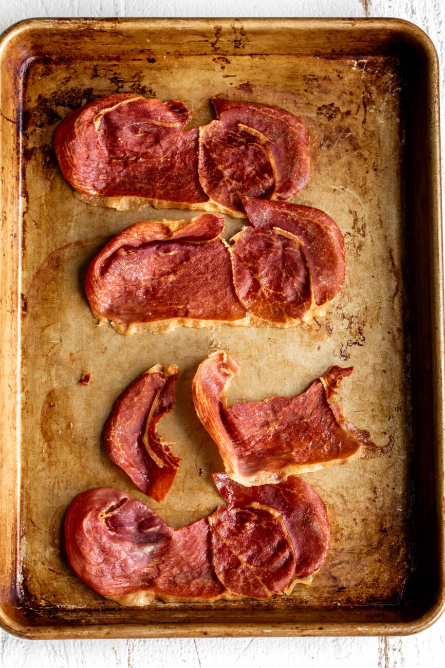 crispy broiled slices of prosciutto on baking sheet.