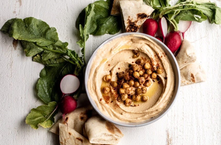 spicy hummus with crispy chickpeas served with pita and radish.