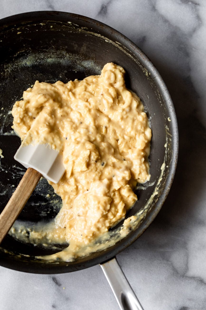 slow scrambled egg in the pan with spatula.