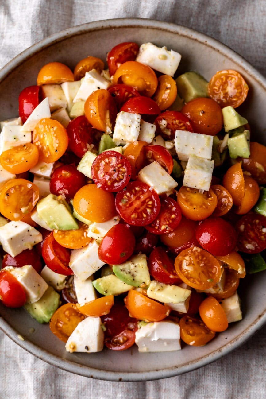 tomato avocado mozzarella simple salad closeup.