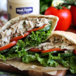 za'atar herb chicken salad with herbs in a pita pocket.