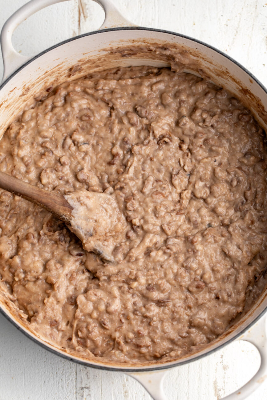 cheesy refried pinto beans in pot.