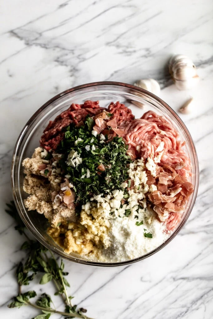 meatball mixture in mixing bowl beef pork and prosiutto
