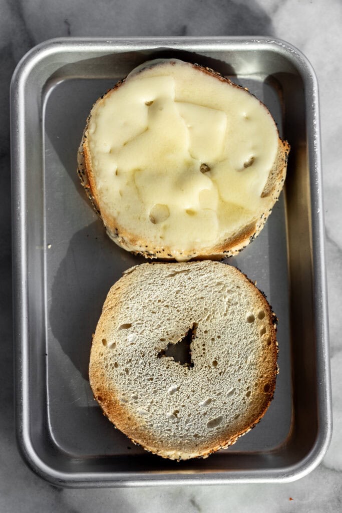 toasted bagel with melted cheese.