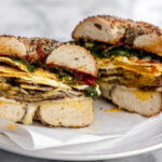 Porchetta egg and cheese breakfast sandwich on a bagel.
