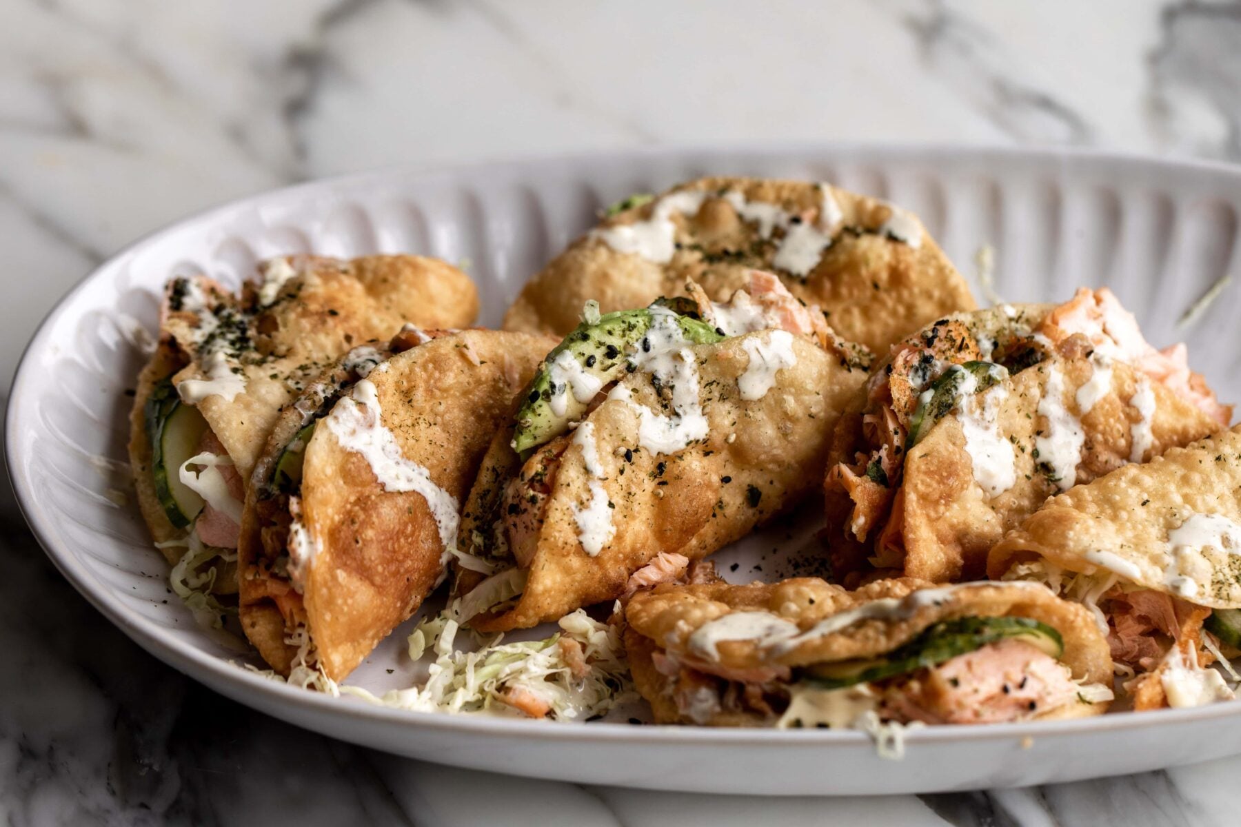 Salmon wonton tacos with yuzu mayo.