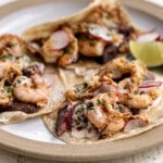 surf and turf tacos with crispy onions and chimichurri aioli.