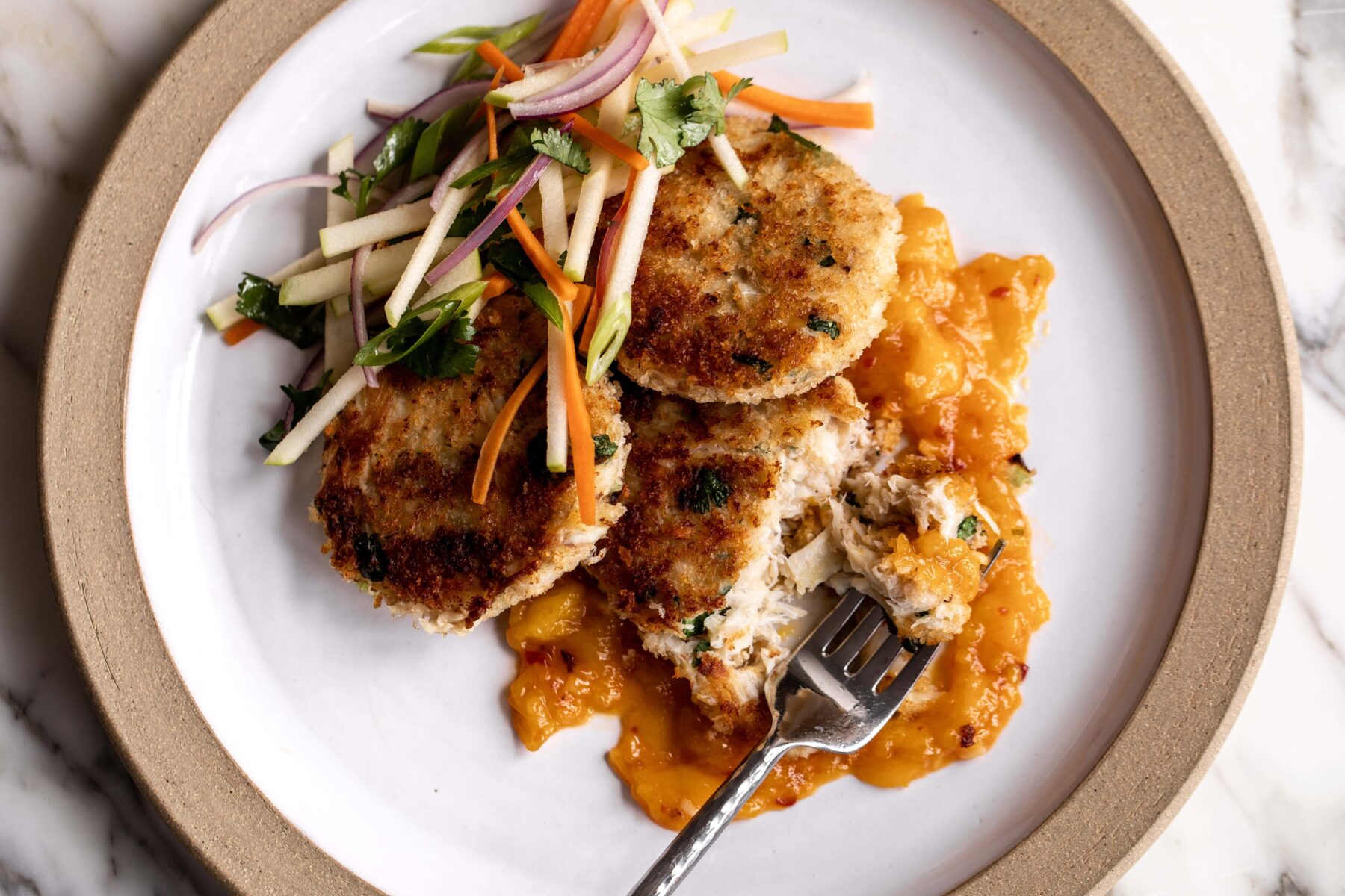 Thai-Inspired Crab Cakes with Mango Chutney & Apple Slaw.