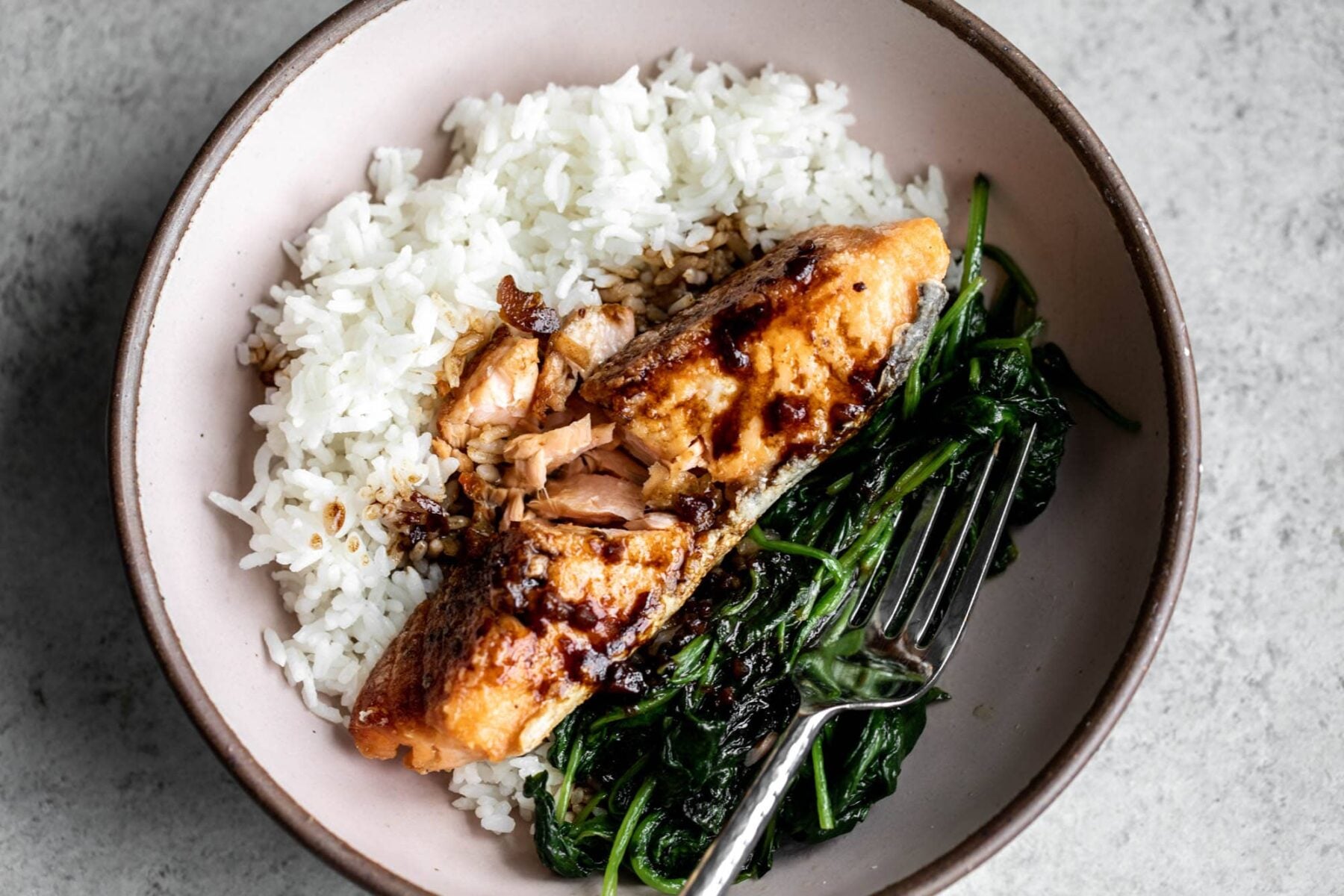 Crispy salmon with soy tamarind sauce, spinach and rice. 