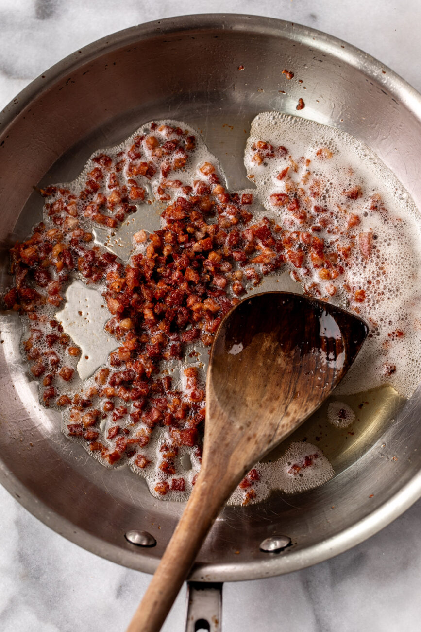 cooked diced pancetta in sauté pan.