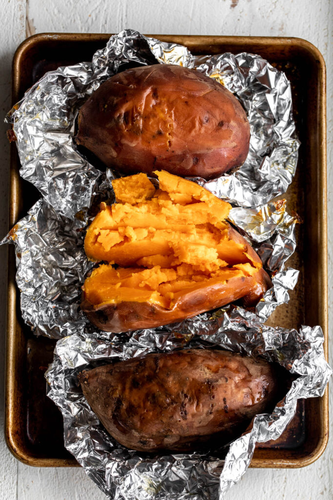 roasted sweet potatoes halved on baking sheet