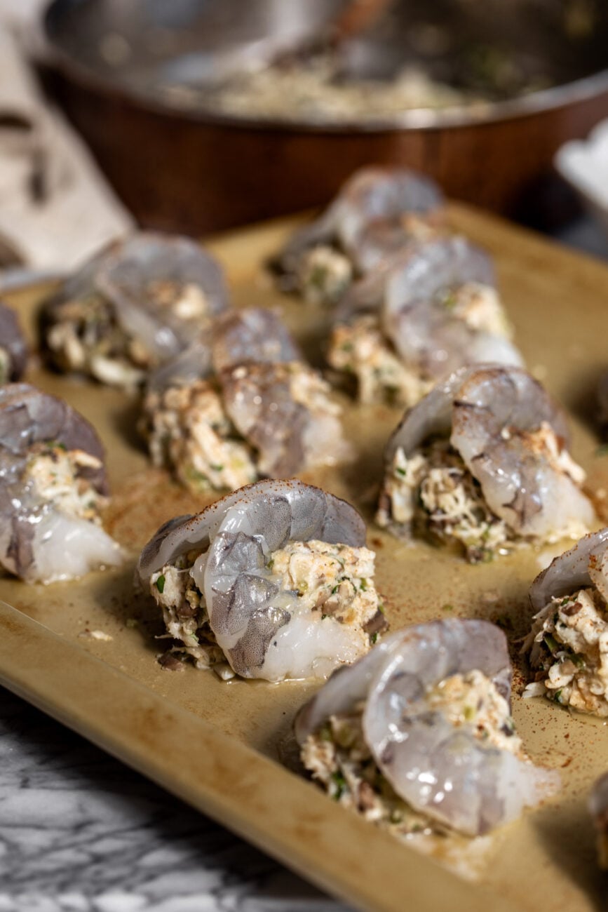 assembled baked stuffed shrimp on baking sheet.