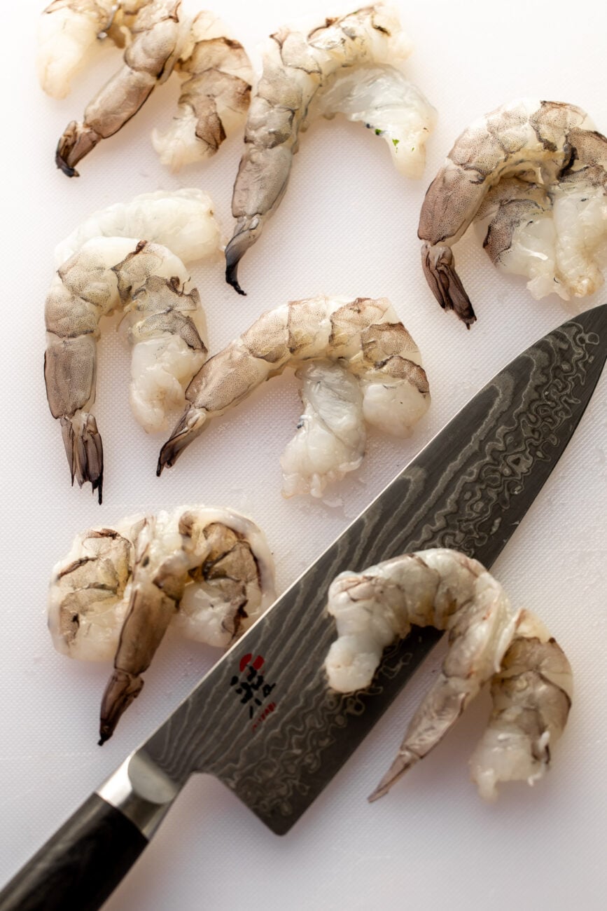 butterflied shrimp on cutting board.