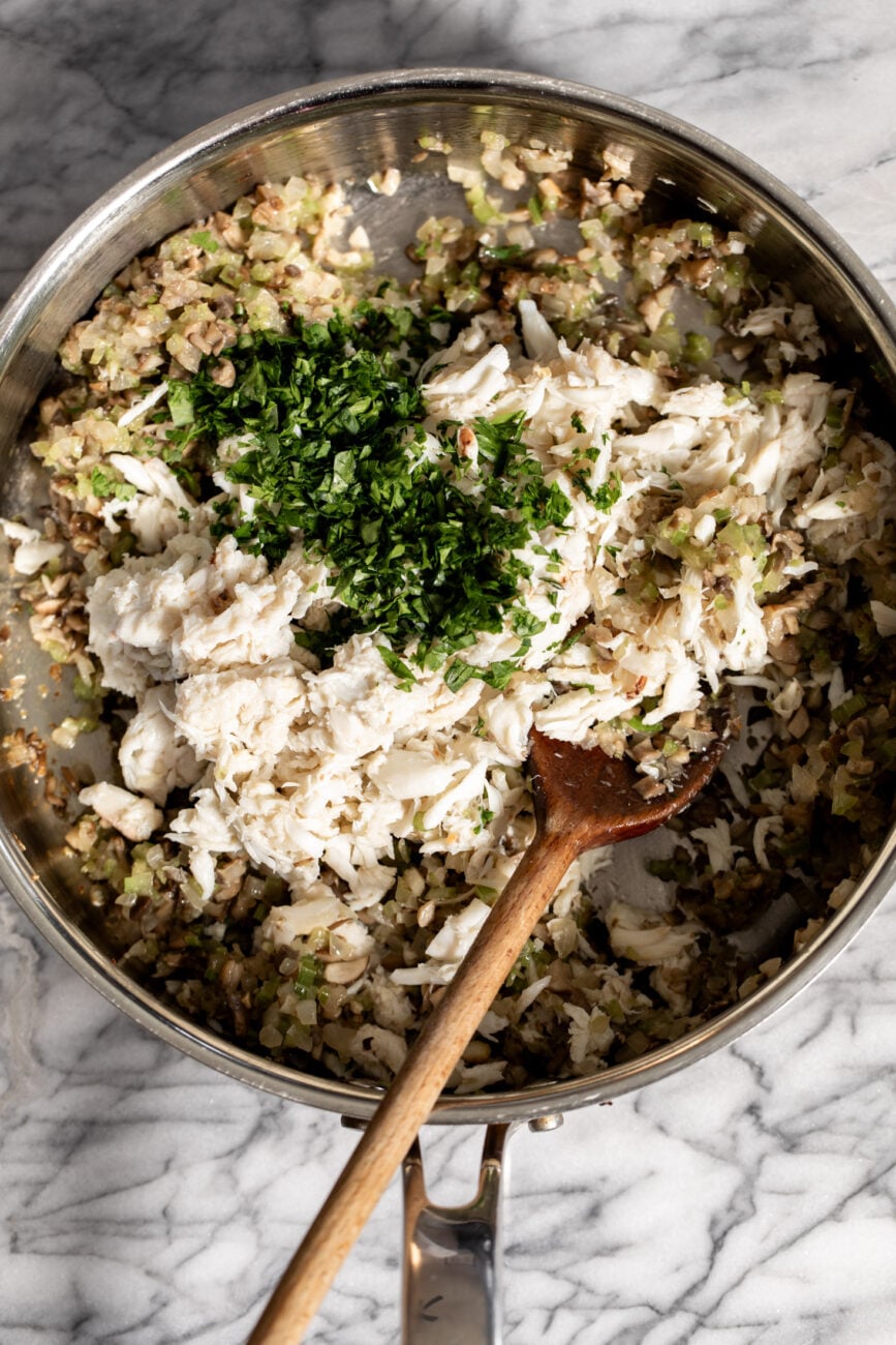 sautéed vegetables with crabmeat and parsley.