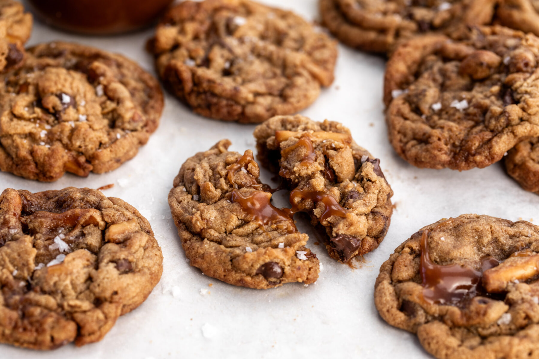 chocolate caramel peanut butter pretzel dough with sea salt broken in half.