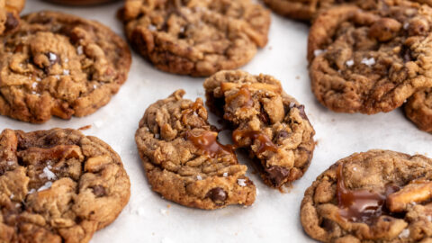 chocolate caramel peanut butter pretzel dough with sea salt broken in half.