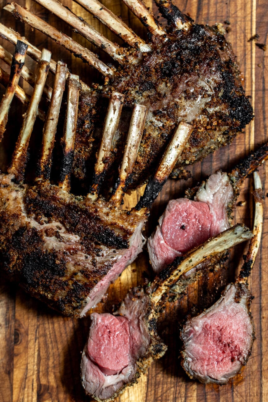 rack of lamb resting on cutting board.
