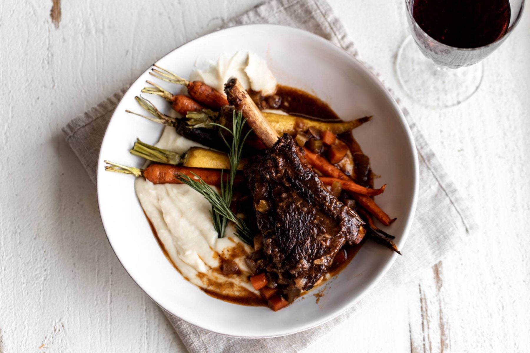 Red Wine Braised Short Ribs with Celery Root Purée roasted carrots and rosemary.