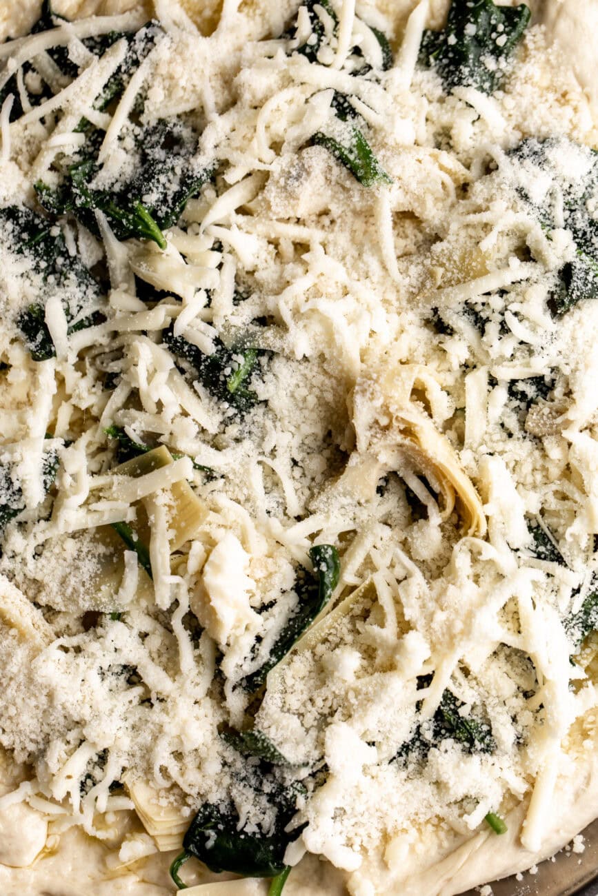 spinach artichoke pizza with mozzarella spinach artichoke and Parmesan.