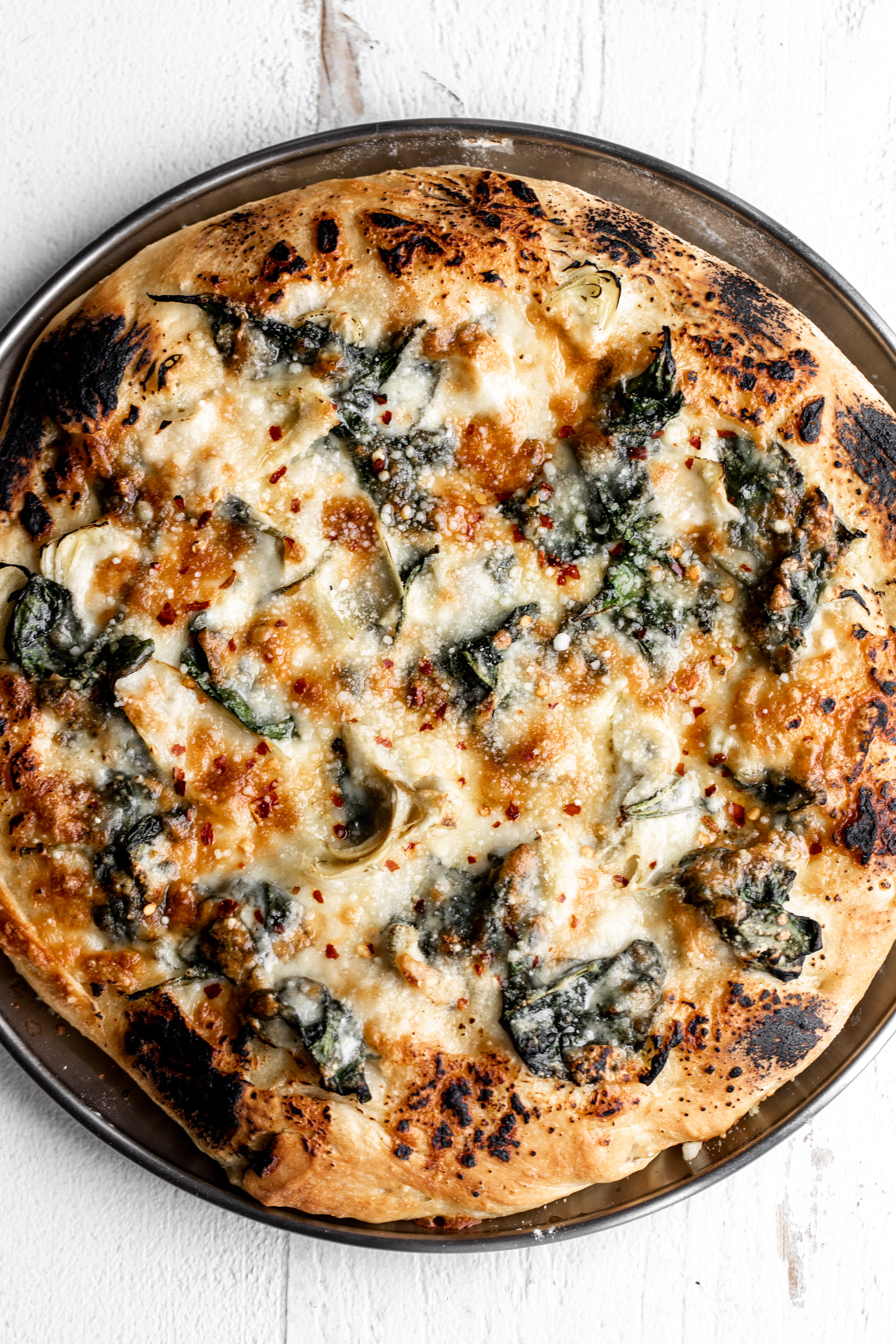 spinach artichoke pizza out of the oven