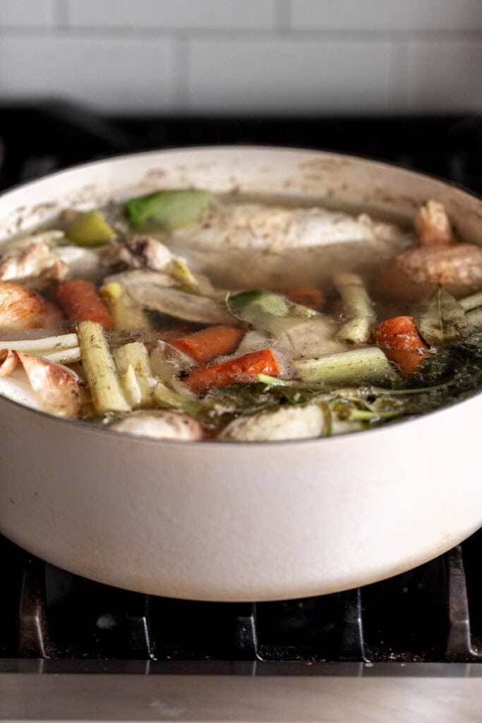 simmered chicken broth in pot.