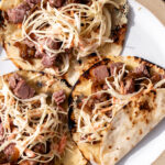Corned Beef Tacos with Guinness Caramelized Onions and creamy slaw.