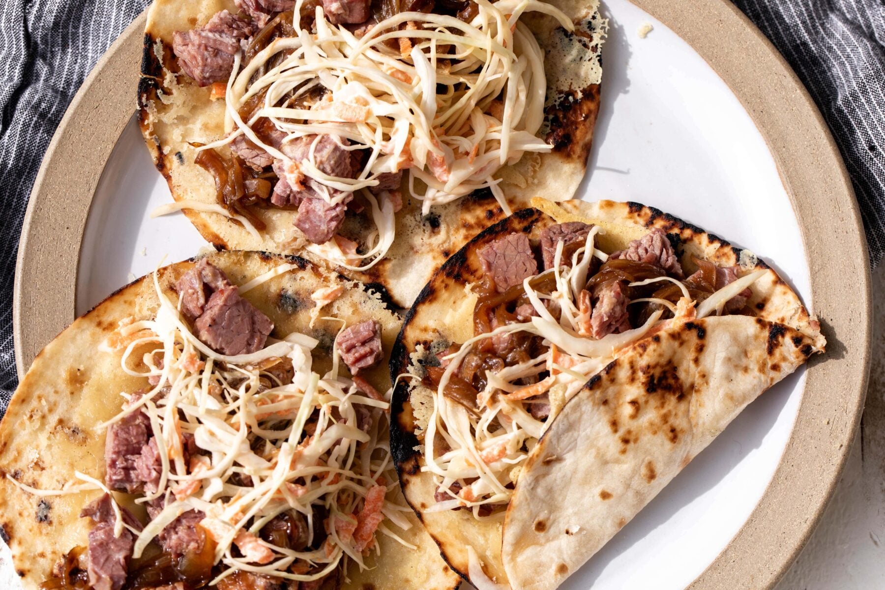 Corned Beef Tacos with Guinness Caramelized Onions and creamy slaw.