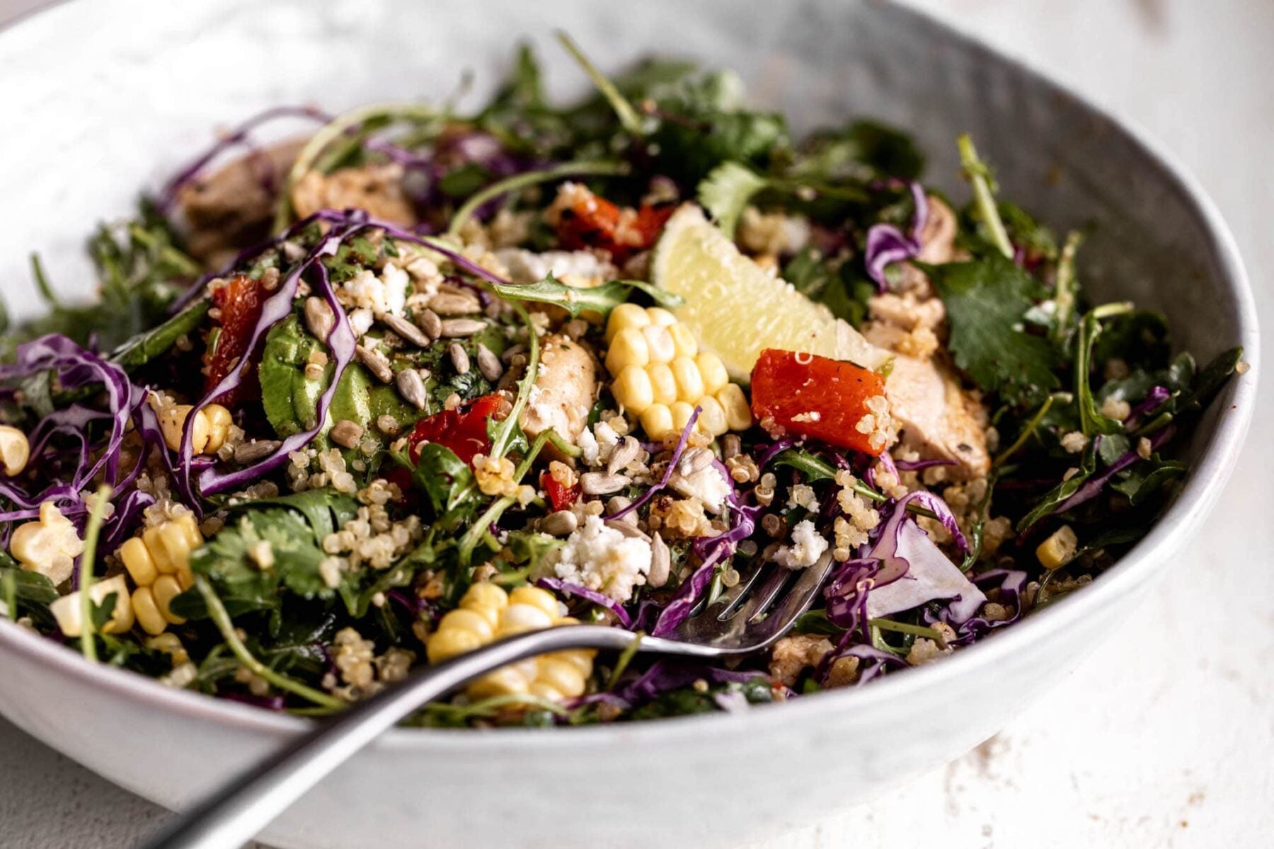 elote quinoa salad with roasted red pepper avocado and lime chicken.