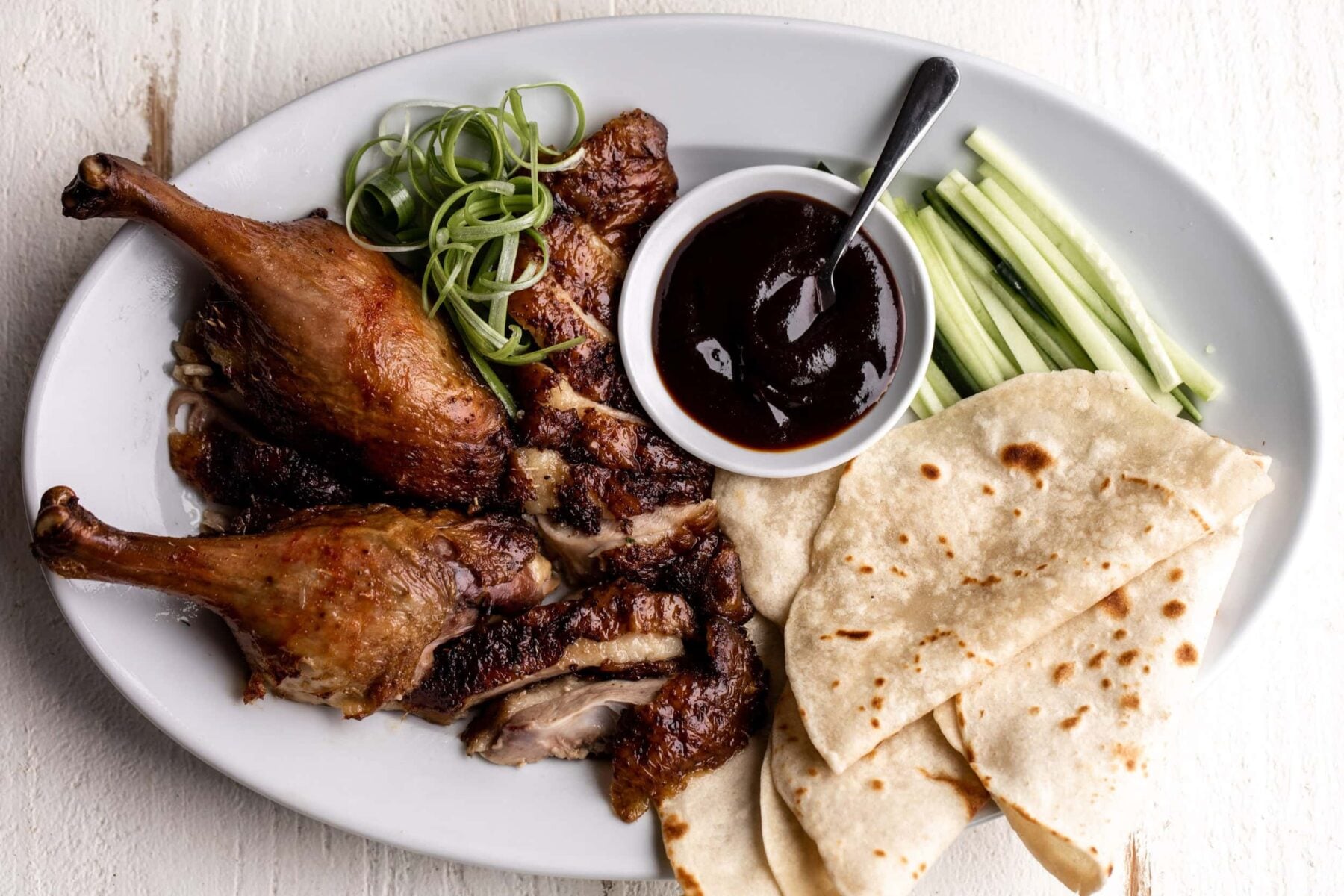 Mandarin-Style Pancakes with peking duck, green onion and hoisin.