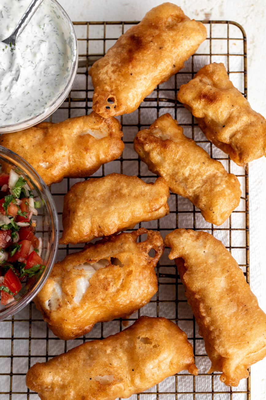 fried crispy beer battered fish on cooling rack.