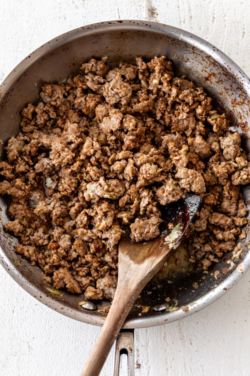 cooked seasoned pork filling in sauté pan.