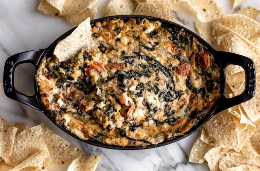 Hot and spicy creamy spinach dip with tortilla chip.