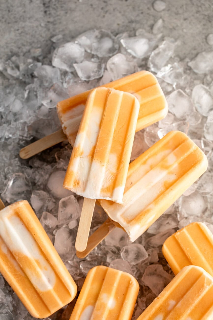 orange creamsicle ice pops on ice bed.