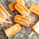 orange creamsicle ice pops on bed of ice.