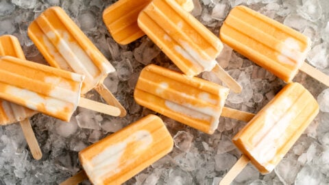 orange creamsicle ice pops on bed of ice.