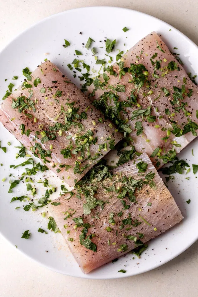 filets of mahi mahi with fresh chopped herbs
