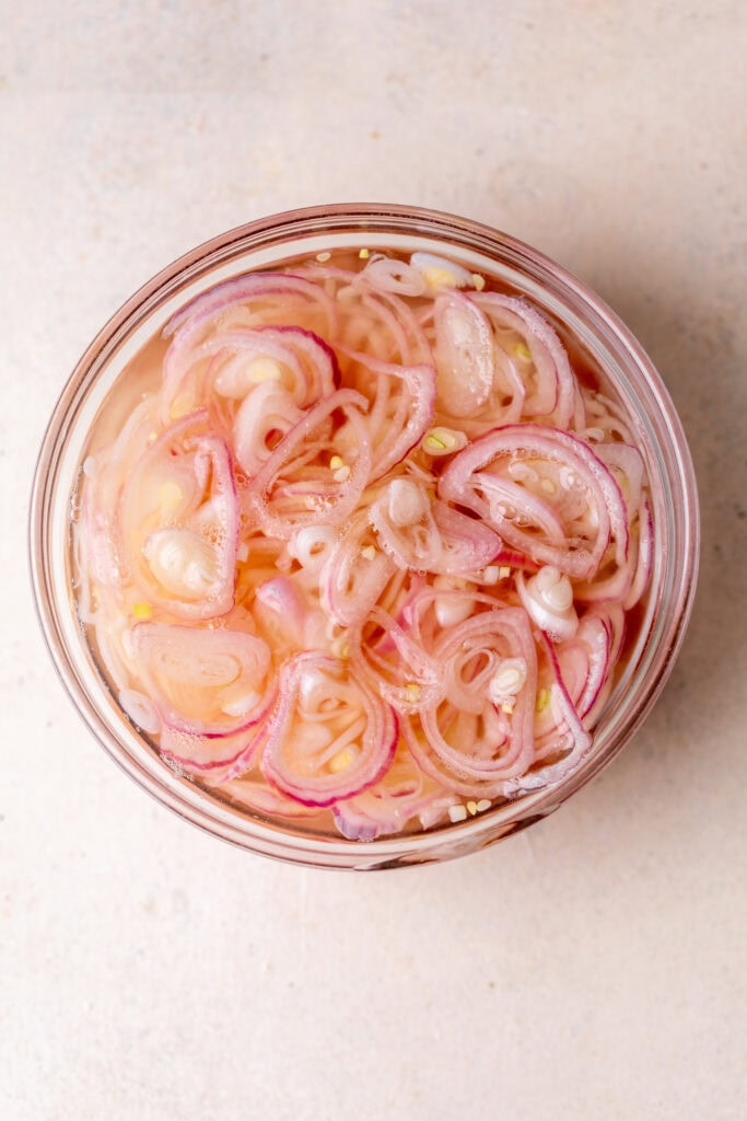 pickled shallots in glass bowl.