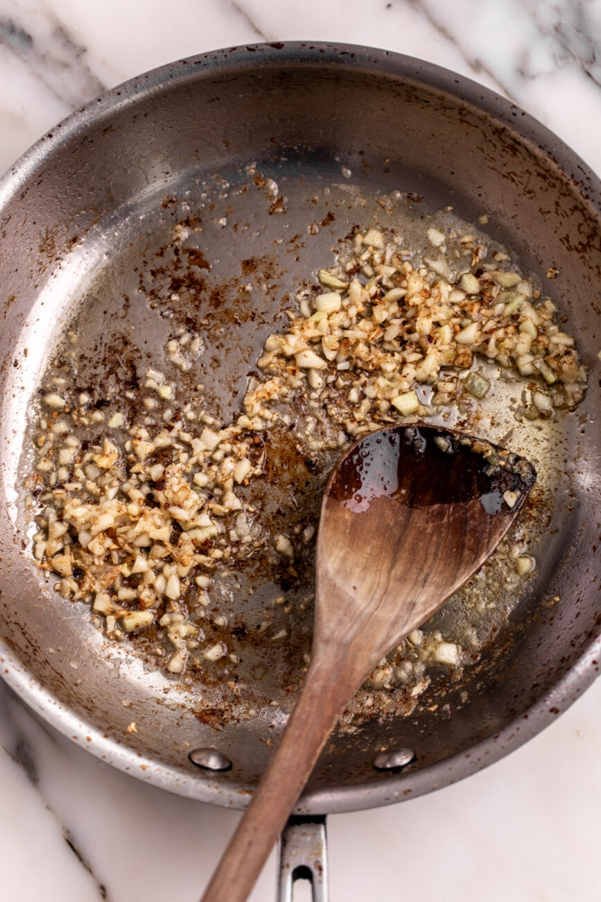 sautéed garlic with leftover shrimp fond in sauté pan.