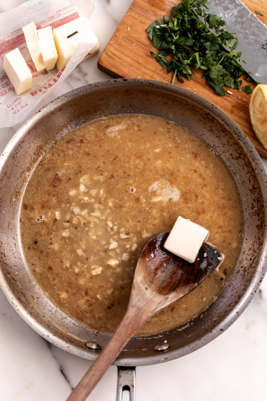 butter whisked into butter sauce with parsley and lemon.