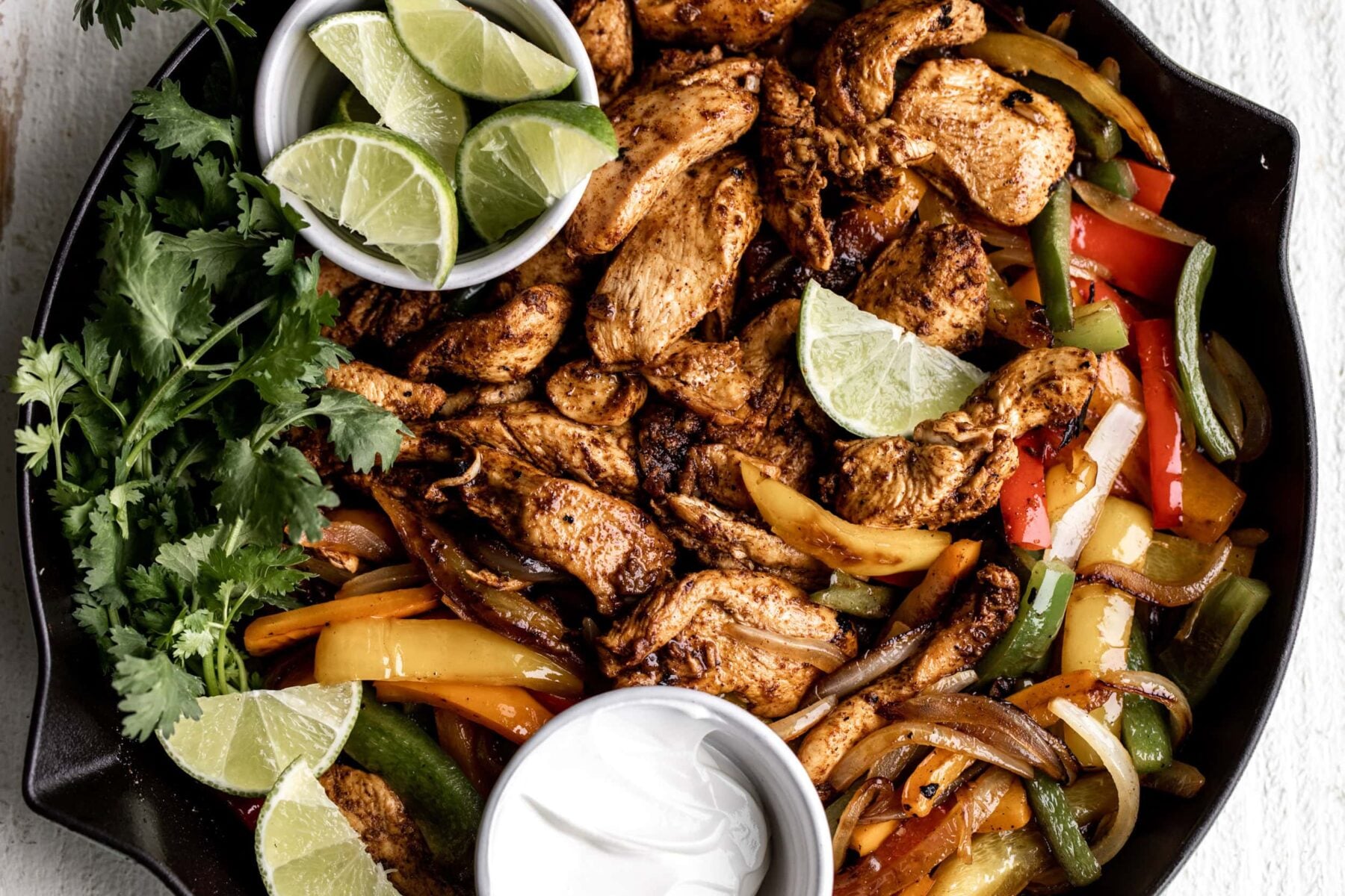 tequila lime and chili chicken fajitas with bell peppers and onion.